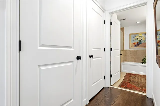 a view of a hallway with wooden floor