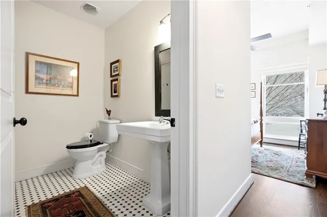 a bathroom with a toilet and a shower