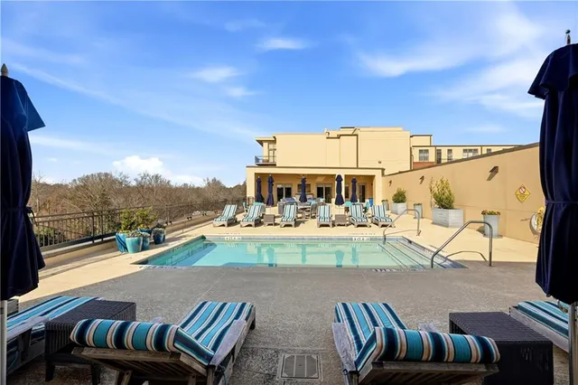a view of swimming pool with seating area and hardwood floor
