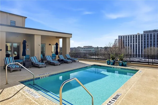a view of a swimming pool and lounge chairs