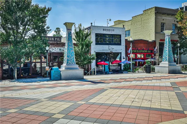 a front view of building with cars parked