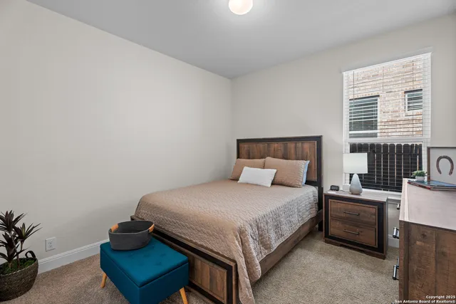 a bedroom with a bed and a chair