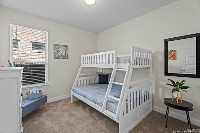 a bedroom with furniture and a window