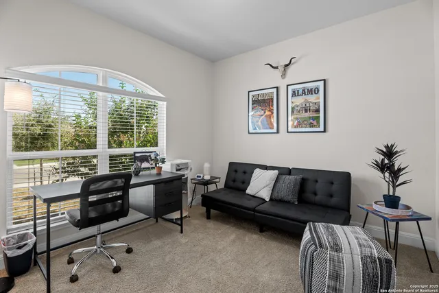a living room with furniture and a large window