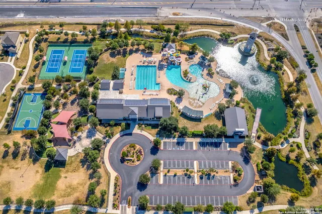 an aerial view of a swimming pool with outdoor seating