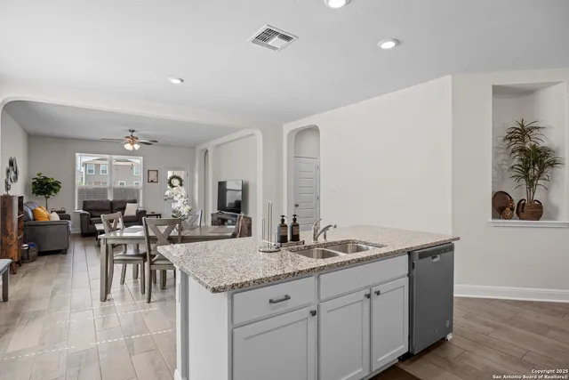 a living room with granite countertop furniture a dining table and chairs