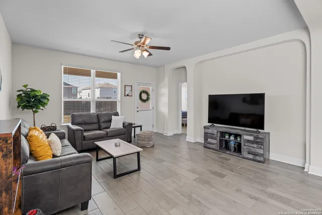 a living room with furniture and a flat screen tv