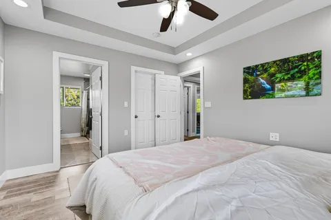 a bedroom with a bed and a chandelier