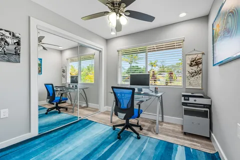 a view of a livingroom with workspace and a window