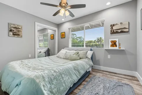 a bedroom with a large bed and a window