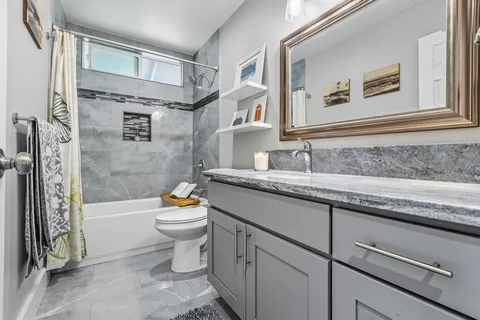 a bathroom with a sink toilet and shower