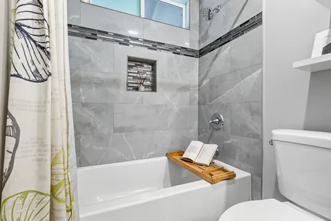 a bathroom with a toilet and a bathtub