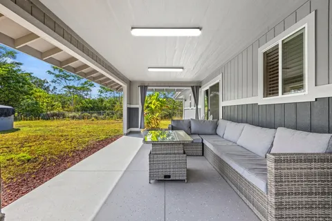 a balcony with furniture and garden view