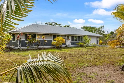 a view of a house with pool patio and a yard
