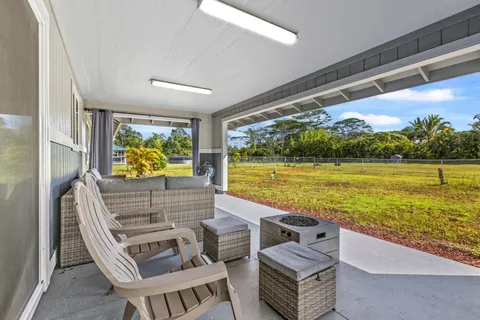 a view of swimming pool with outdoor seating and a yard