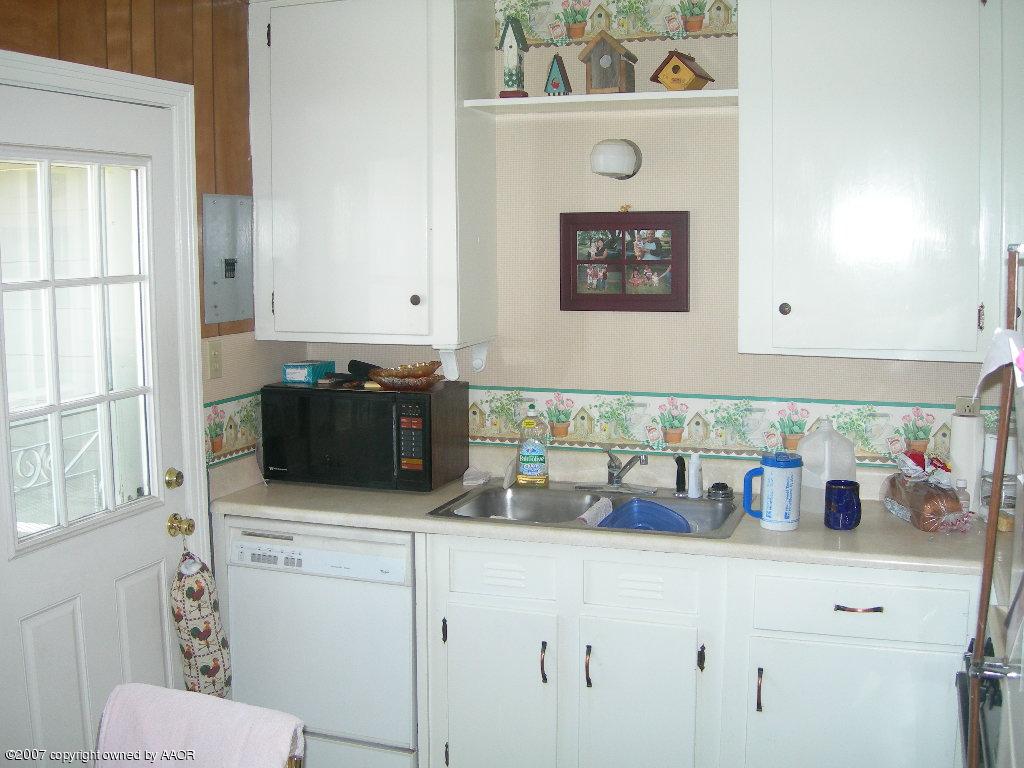 4601 Cline Road Amarillo, TX 79110 - Photo 4 of 9 a kitchen with a microwave and a white stove