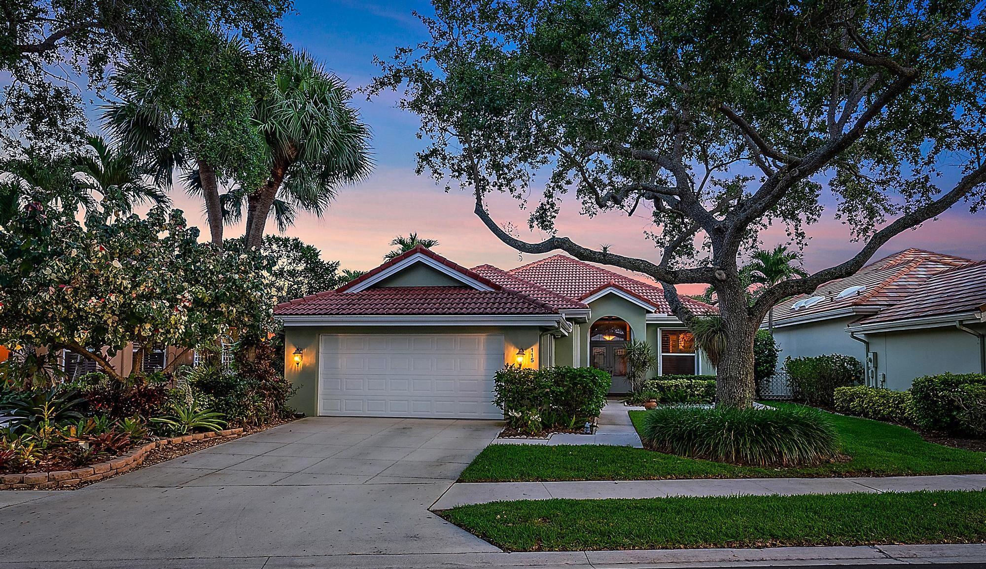 115 South Hampton Drive Jupiter, FL 33458 - Photo 2 of 27 a front view of a house with a garden