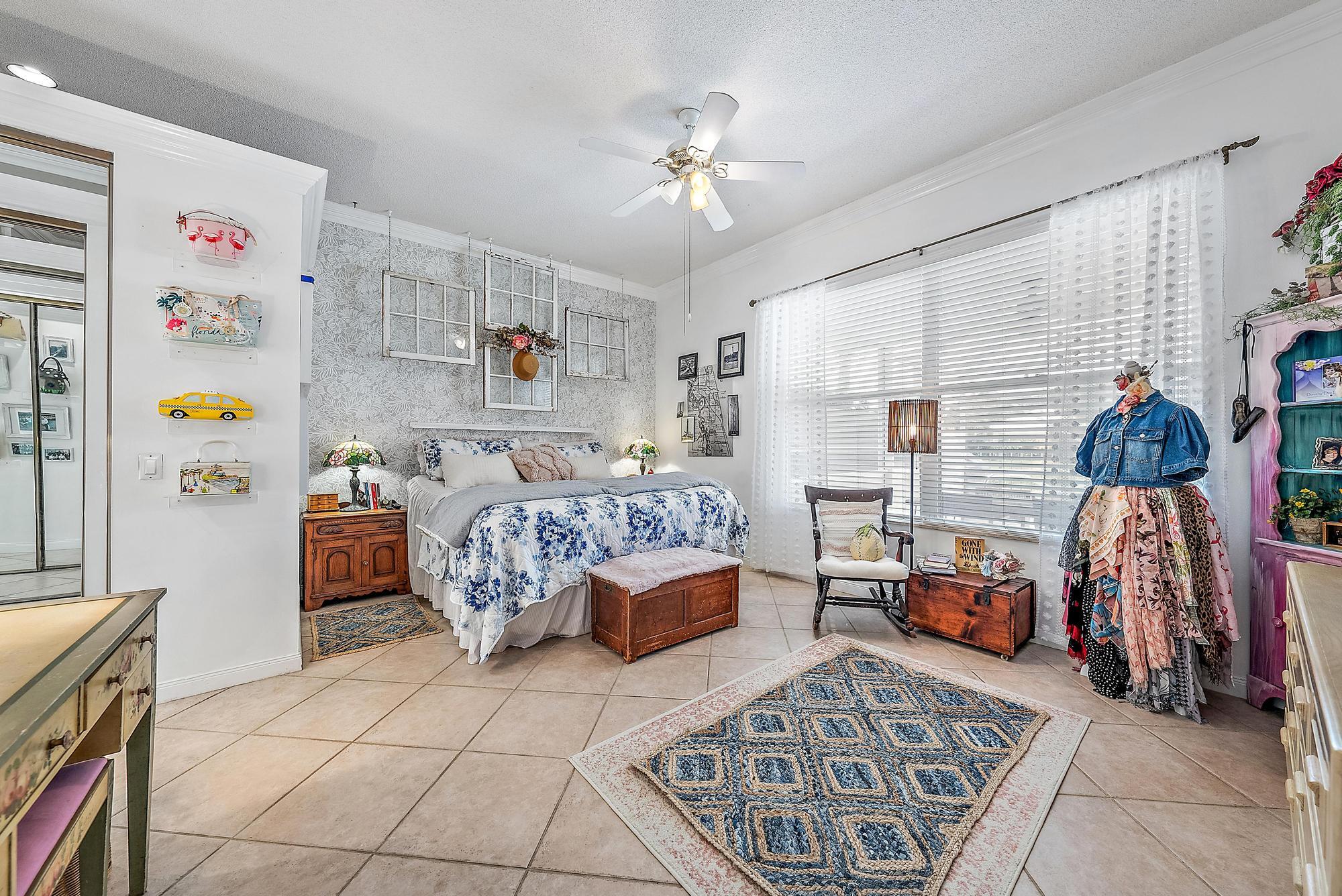 115 South Hampton Drive Jupiter, FL 33458 - Photo 21 of 27 a bedroom with furniture and a chandelier
