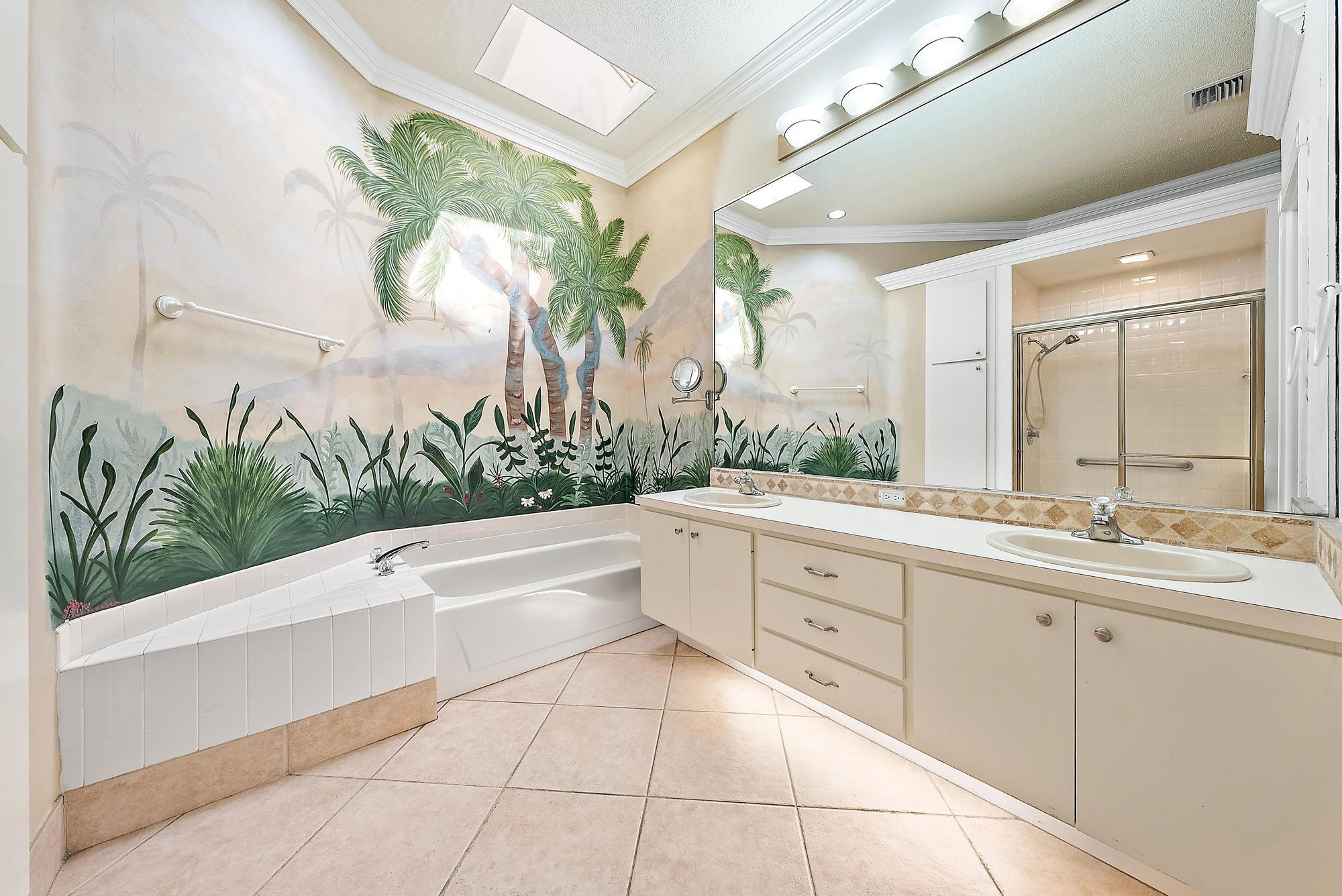 115 South Hampton Drive Jupiter, FL 33458 - Photo 24 of 27 a spacious bathroom with a double vanity sink a mirror and a bathtub