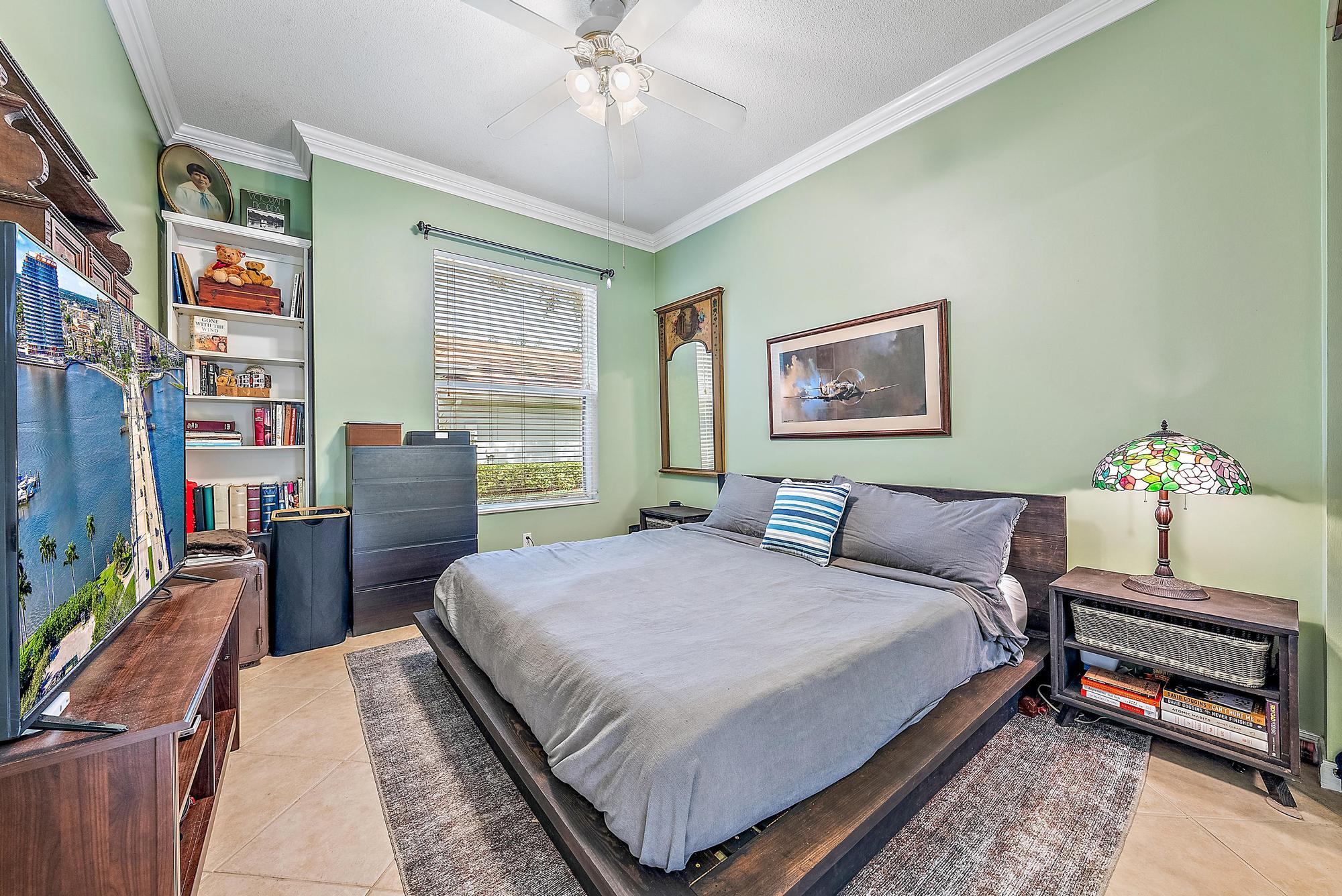 115 South Hampton Drive Jupiter, FL 33458 - Photo 25 of 27 a bedroom with a bed and a chandelier