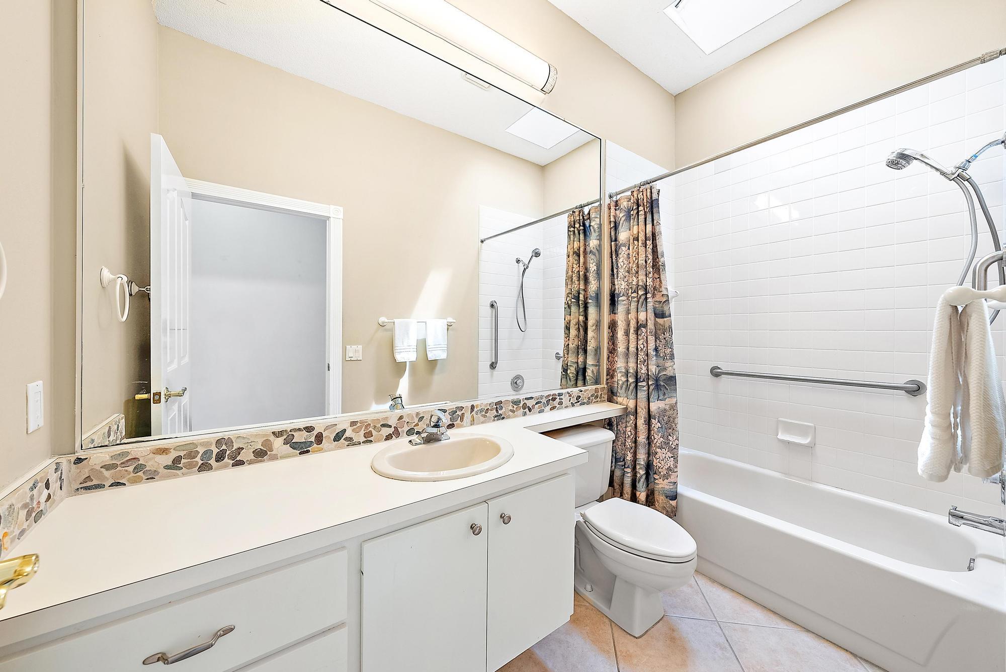 115 South Hampton Drive Jupiter, FL 33458 - Photo 27 of 27 a bathroom with a sink a toilet and shower