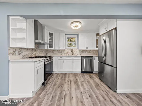 a kitchen with a refrigerator stove and sink