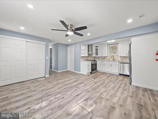 a view of a kitchen with a sink and a refrigerator