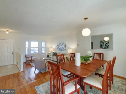 a view of a dining room with furniture and wooden floor