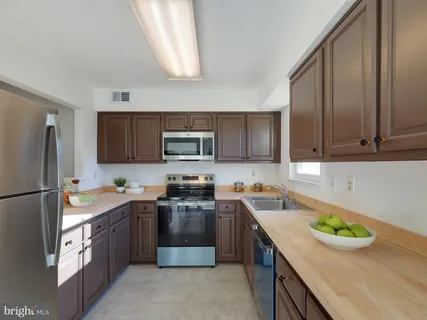 a kitchen with a sink a stove a microwave and refrigerator