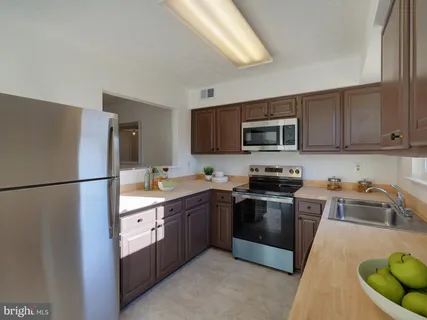 a kitchen with stainless steel appliances granite countertop a refrigerator stove a sink and dishwasher