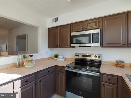 a kitchen with a sink stove and microwave