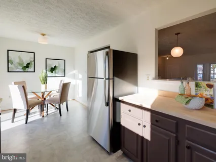 a kitchen with stainless steel appliances granite countertop a sink and a refrigerator