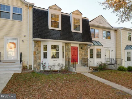 a view of a brick house with many windows