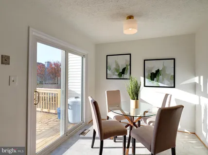a view of a dining room with furniture wooden floor and a potted plant