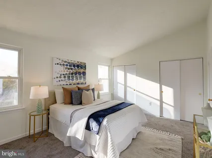 a bedroom with a large bed and a large window