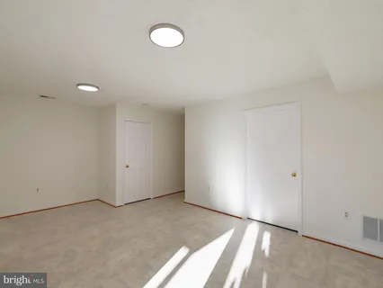 a view of an empty room with glass door and glass door