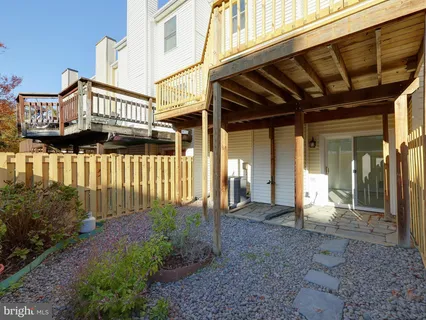 a view of a house with a small porch and wooden floor