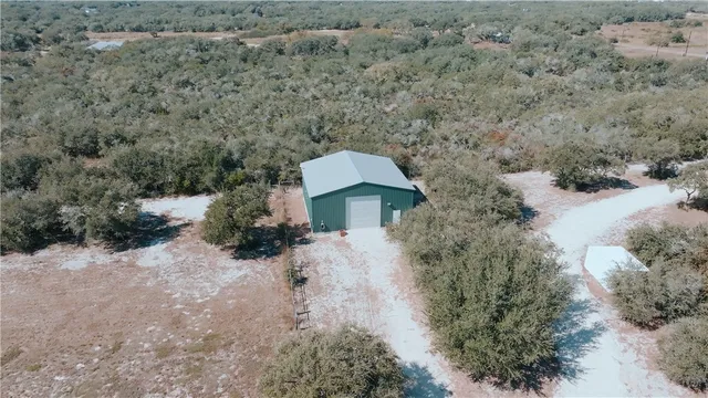 a view of a dry yard with green space