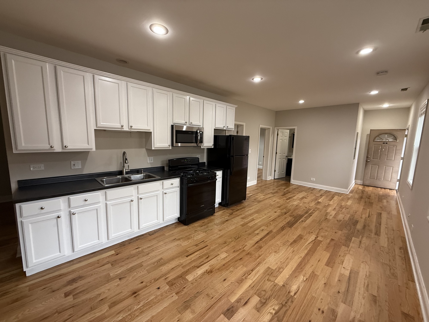 712 South Aberdeen Street, Unit 3B Chicago, IL 60607 - Photo 3 of 9 a kitchen with granite countertop a refrigerator sink and cabinets