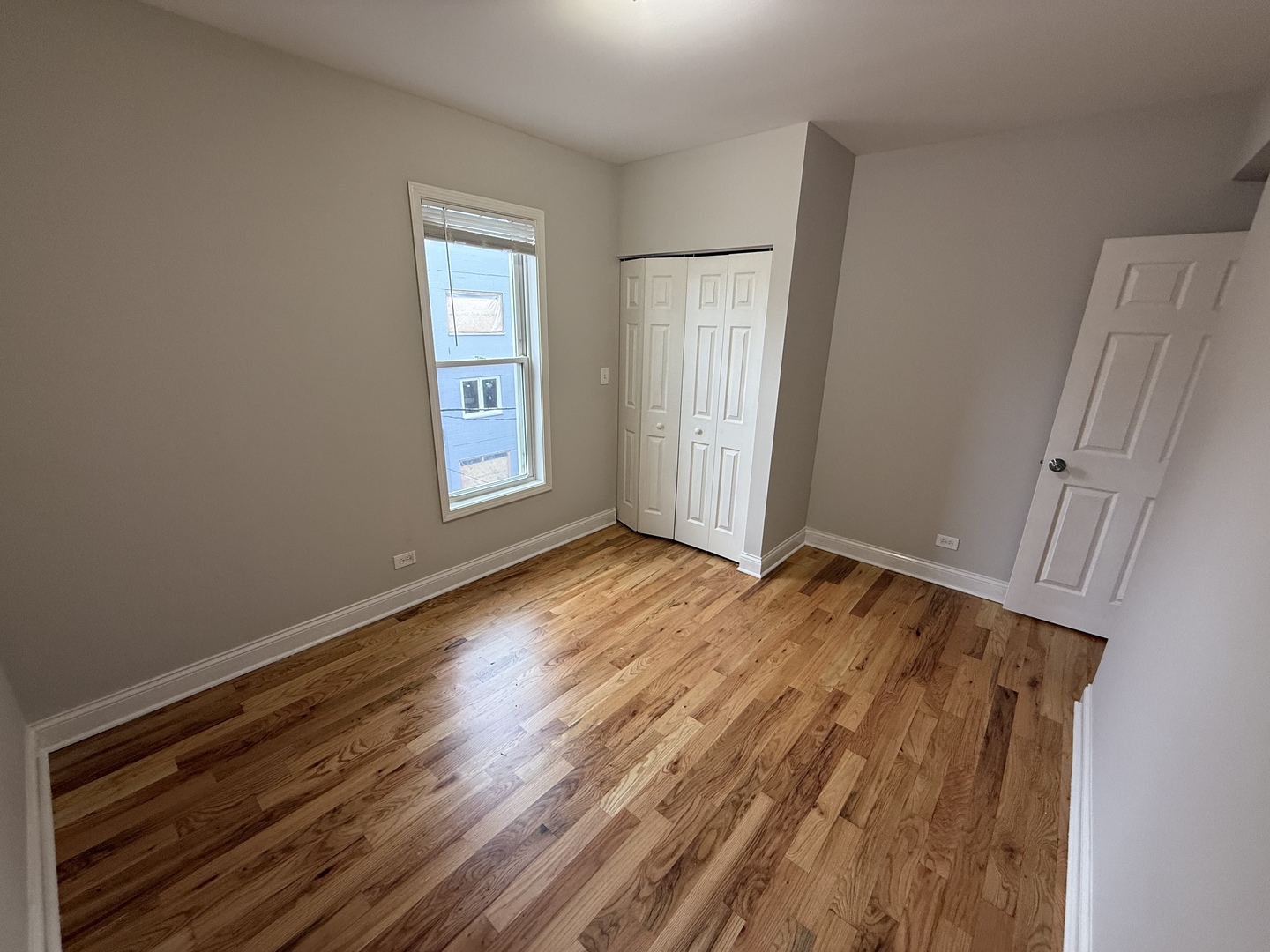 712 South Aberdeen Street, Unit 3B Chicago, IL 60607 - Photo 6 of 9 an empty room with wooden floor and window