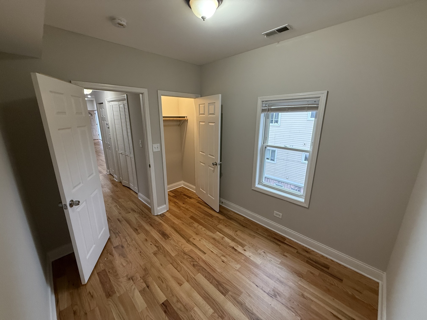 712 South Aberdeen Street, Unit 3B Chicago, IL 60607 - Photo 7 of 9 a view of an empty room with wooden floor and a window