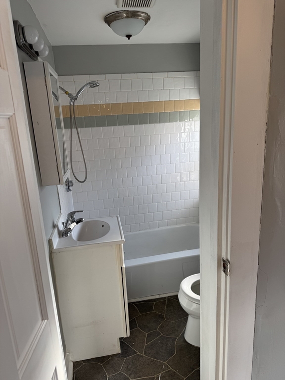 286 South Main Street, Unit 10 Haverhill, MA 01835 - Photo 6 of 11 a bathroom with a sink a toilet and a bathtub