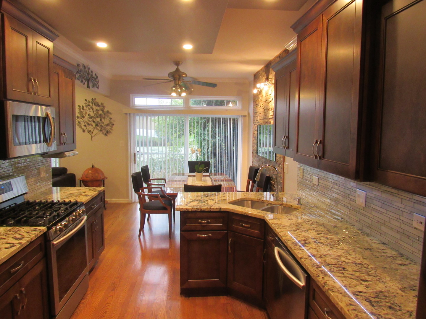 696 Western Lane Addison, IL 60101 - Photo 13 of 36 a kitchen with stainless steel appliances granite countertop a stove a sink and a microwave