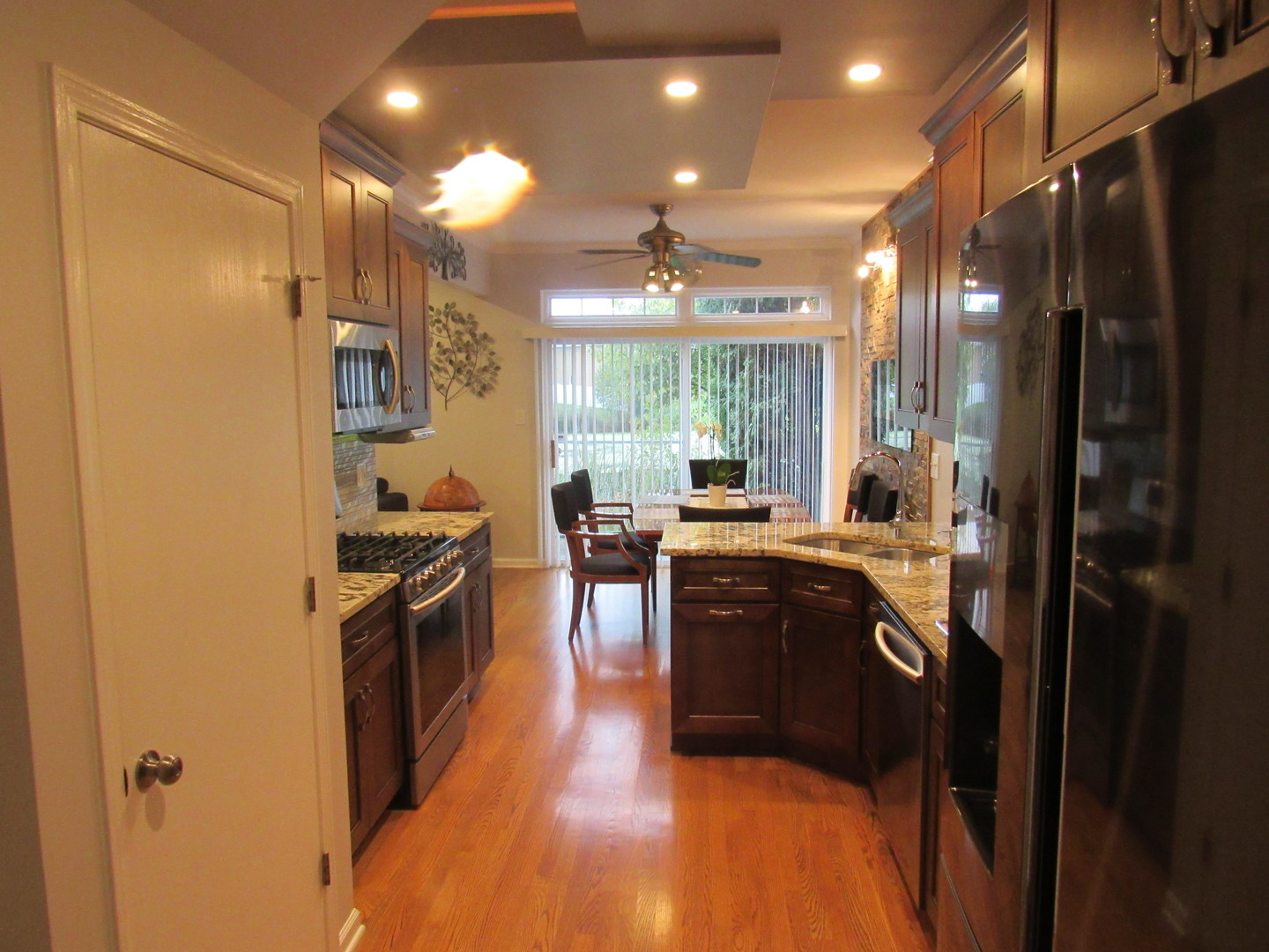 696 Western Lane Addison, IL 60101 - Photo 14 of 36 a large kitchen with stainless steel appliances granite countertop a stove and a refrigerator