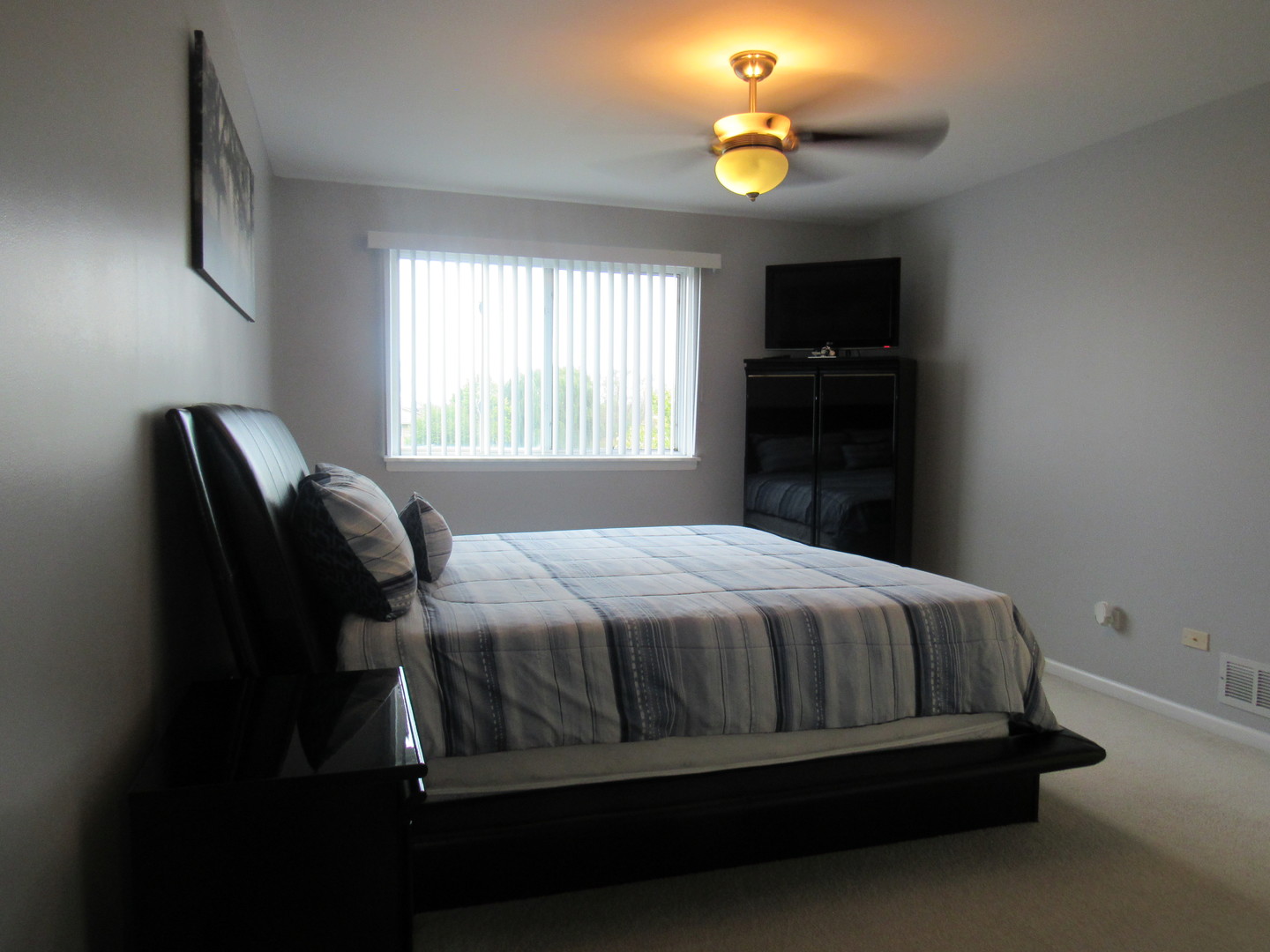 696 Western Lane Addison, IL 60101 - Photo 25 of 36 a bed sitting in a bedroom next to a window
