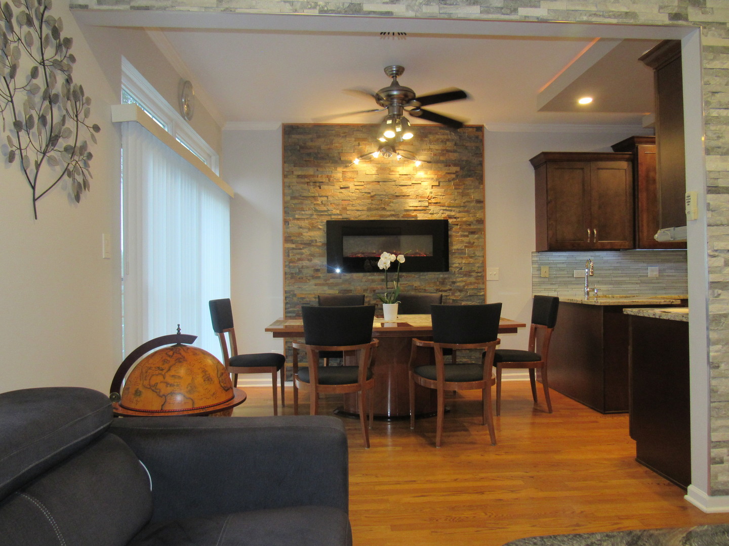 696 Western Lane Addison, IL 60101 - Photo 8 of 36 a living room with furniture a fireplace and a flat screen tv