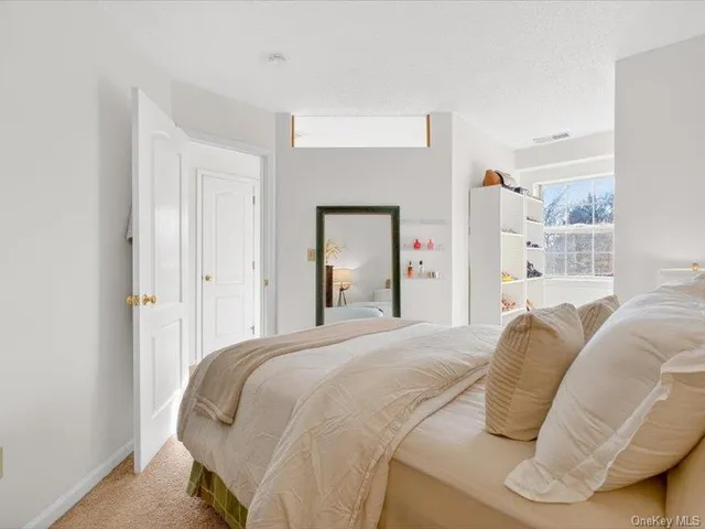 a bedroom with a bed and mirror