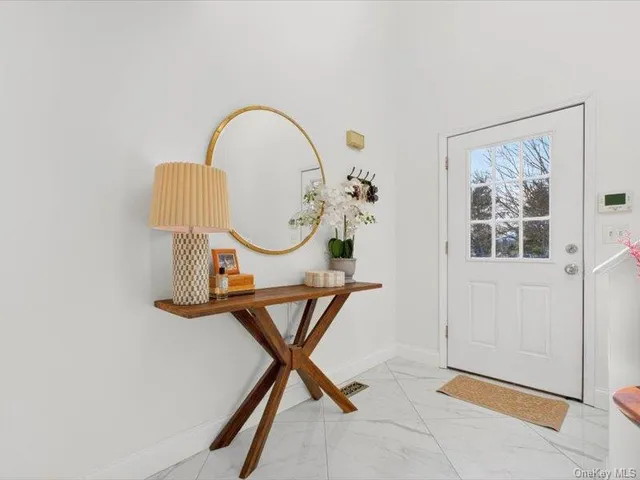 a view of a livingroom with furniture and a window