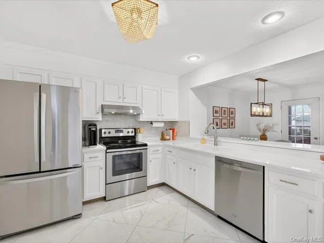 a kitchen with a stove top oven sink and cabinets