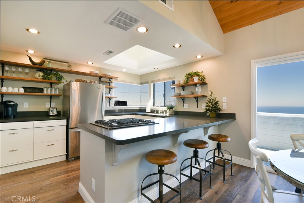 2640 Maple Morro Bay, CA 93442 - Photo 10 of 29 a kitchen with stainless steel appliances granite countertop a table chairs sink and cabinets